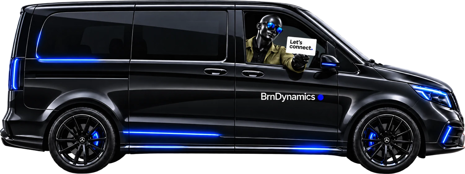 A BrnDynamics van with a team member leaning from the window holding a card that reads Let's connect